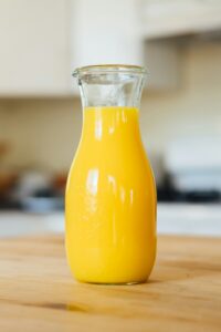 orange juice in a glass jar. Ready to mix into the Morir Soñando Mocktail.