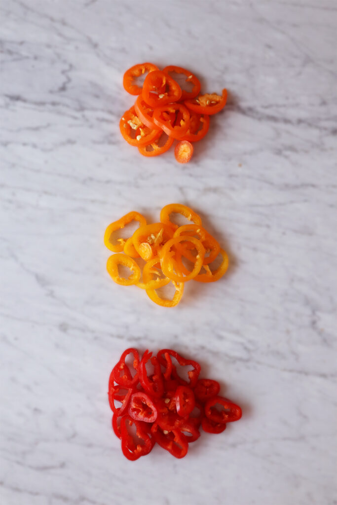 slices mini bell pepper, colors orange, yellow, and red. All added to scrambled tofu.