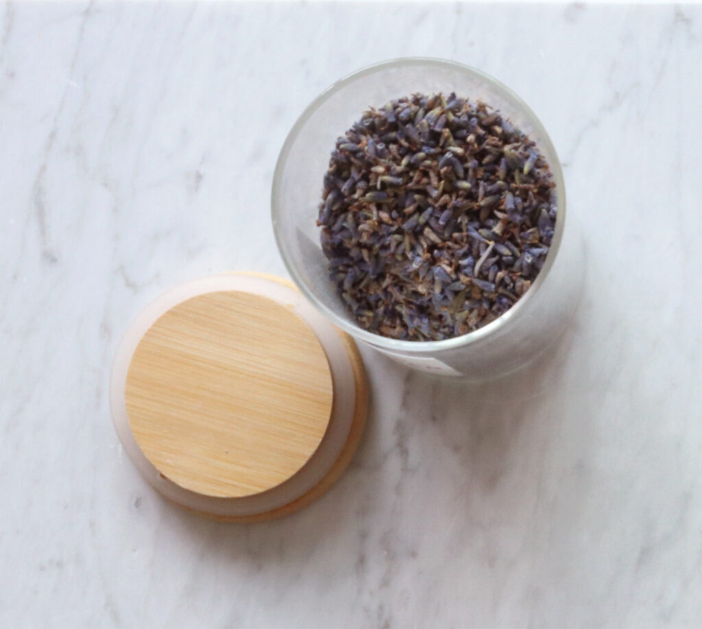 Lavender buds in a jar, wooden lid on the side