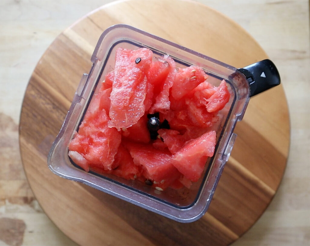 Pieces of watermelon chunks in a blender.