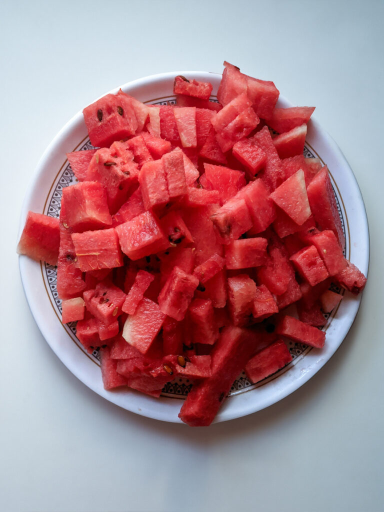 Watermelons cut into pieces on a plate.