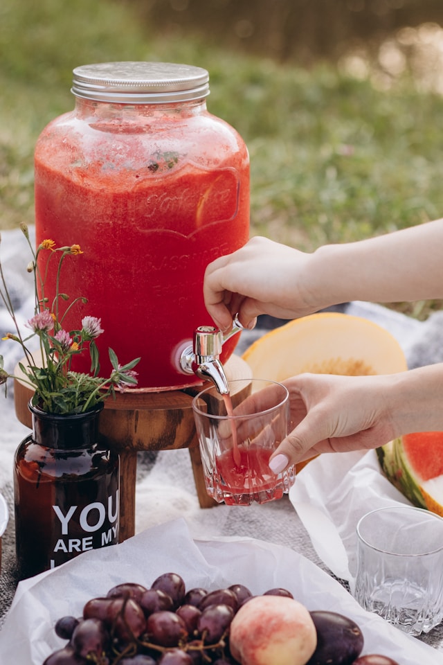 Watermelon pouring into a glass cup.