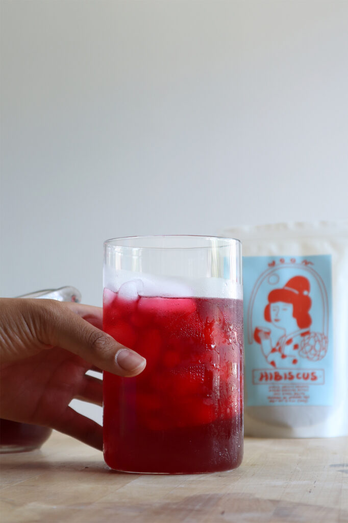 Cup of hibiscus tea held by hand