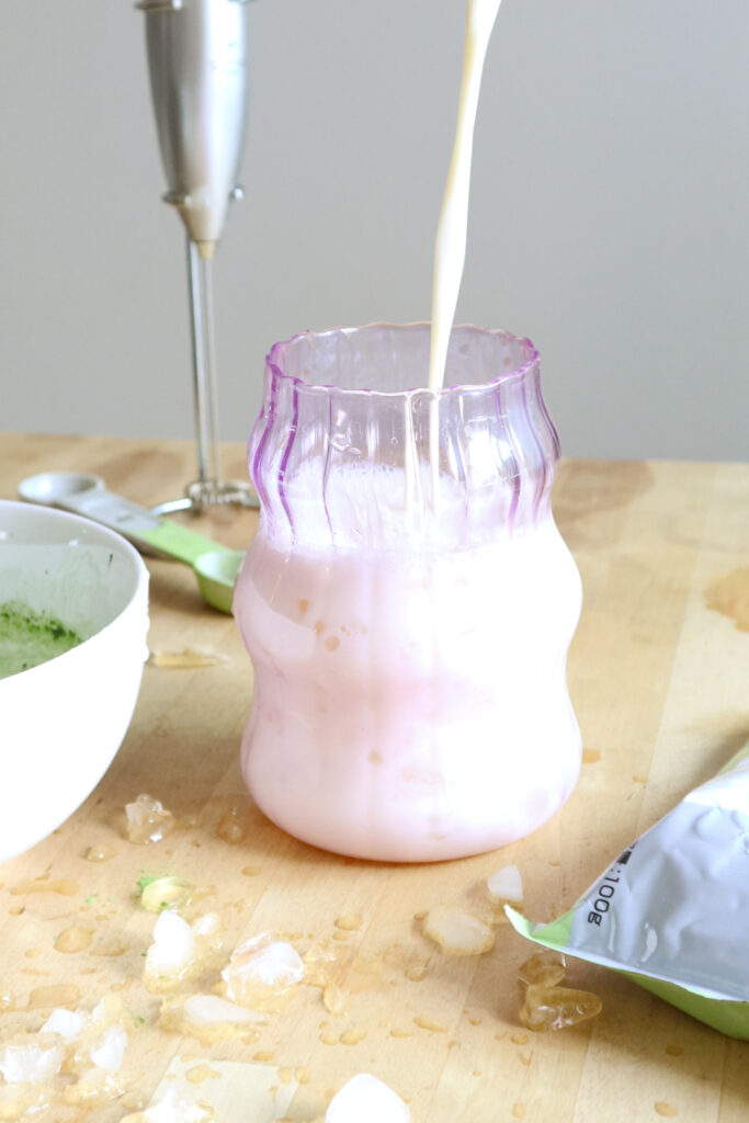 Milk poured into glass cup.